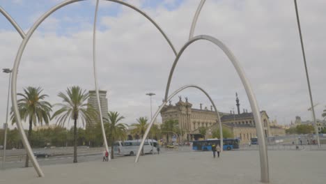 an amazing long tilting down view of aduana, customs building at barcelona harbour, catalonia, spain over the fence.