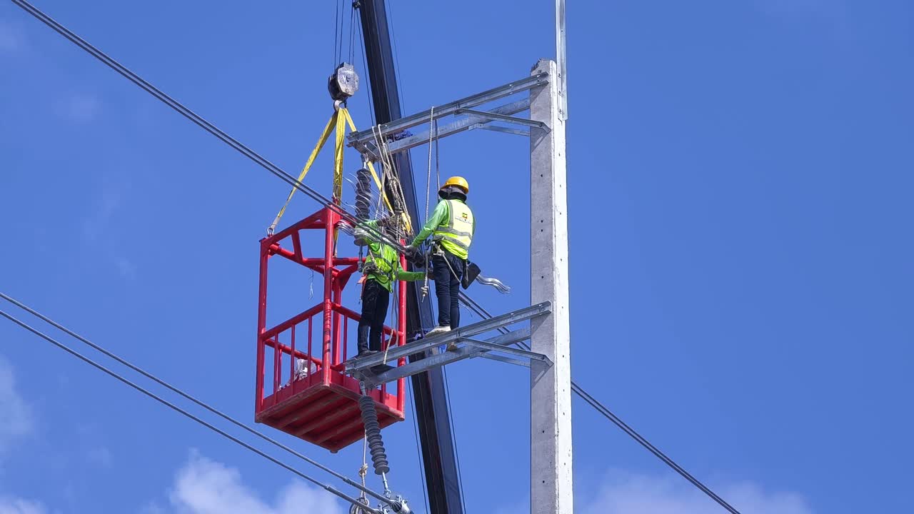 Utility Workers Performing Aerial Maintenance on Power Lines