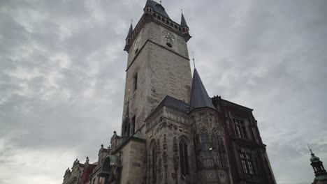 old town square and orloj astronomical clock on hall building in prague, tilt up low angle view, no people