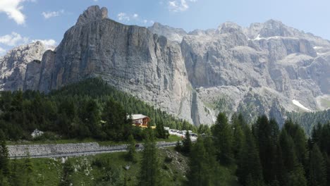 Cyclist-on-a-road-in-a-beautiful-nature-mountain-area-with-background,-Dolomites,-Italy