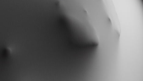 a scary face and hands appear from the white surface