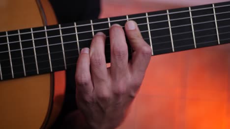 anonymous man playing song on guitar