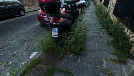 moped and cars on a cobblestone street