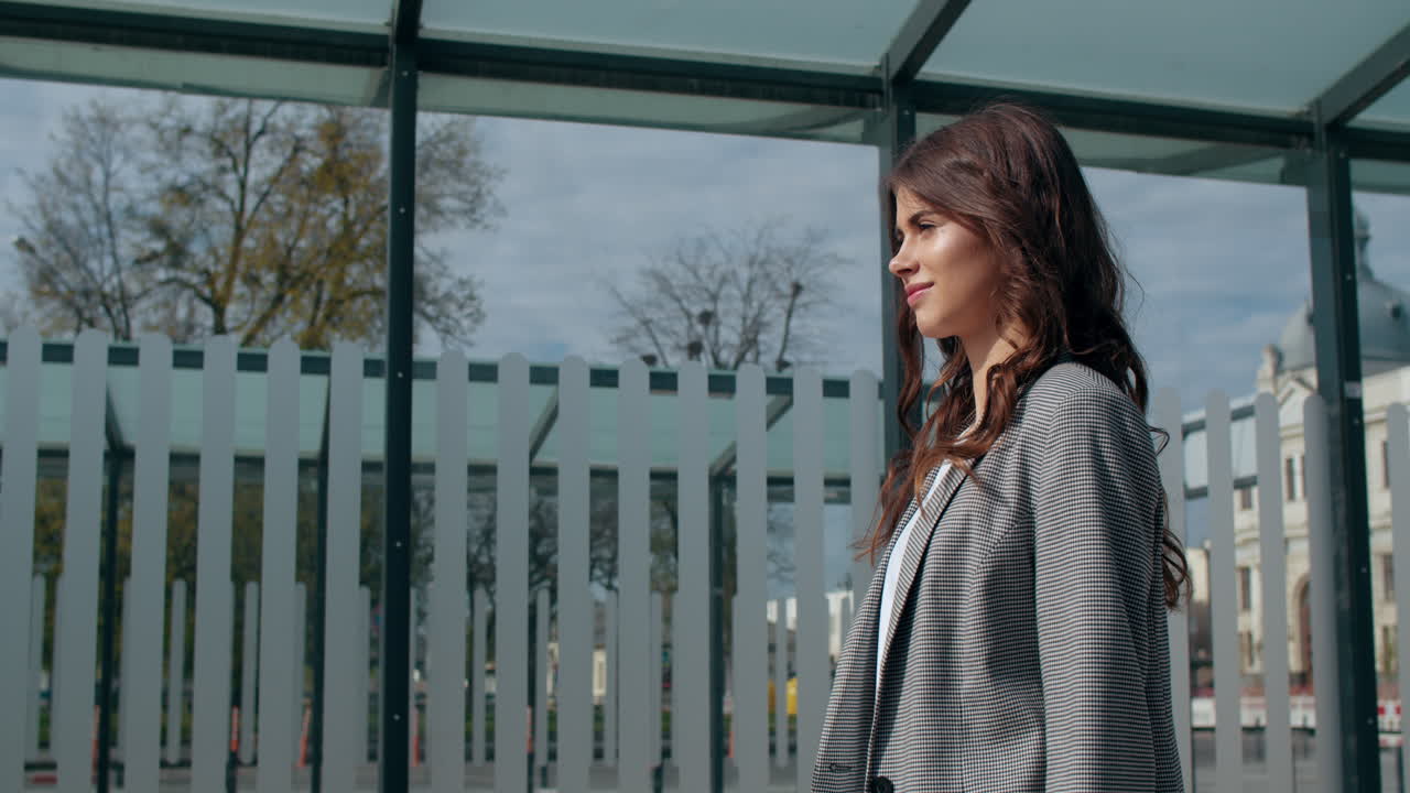Profile of a Young Woman Standing in a Modern Urban Environment