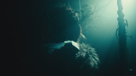 the witch makes a gesture of cutting her throat