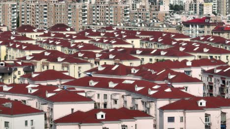 drone aerial view of crowded residential buildings with red roof