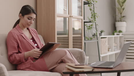 woman working from home on a tablet and laptop