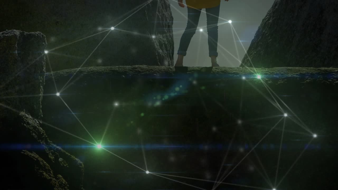 Hiker stepping onto canyon ledge and activating glowing network with lens flares for tech demo