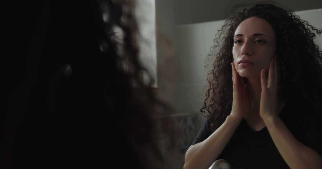 Sad woman washing her face with water