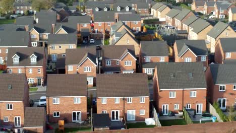property ladder new british housing estate aerial view overlooking rooftops slow dolly right shot
