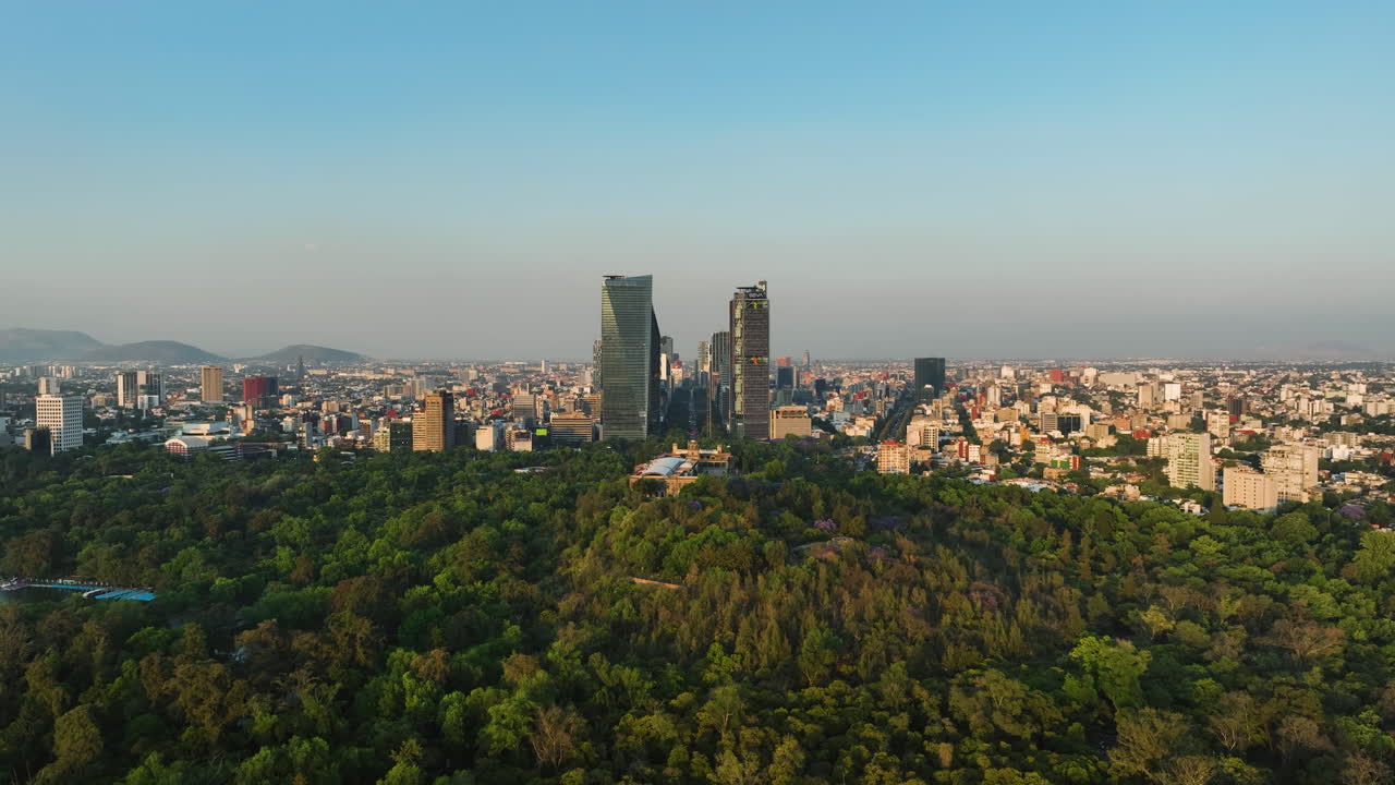 Aerial view flying over the Chapultapec park and castle, golden hour in CDMX Mexico City
