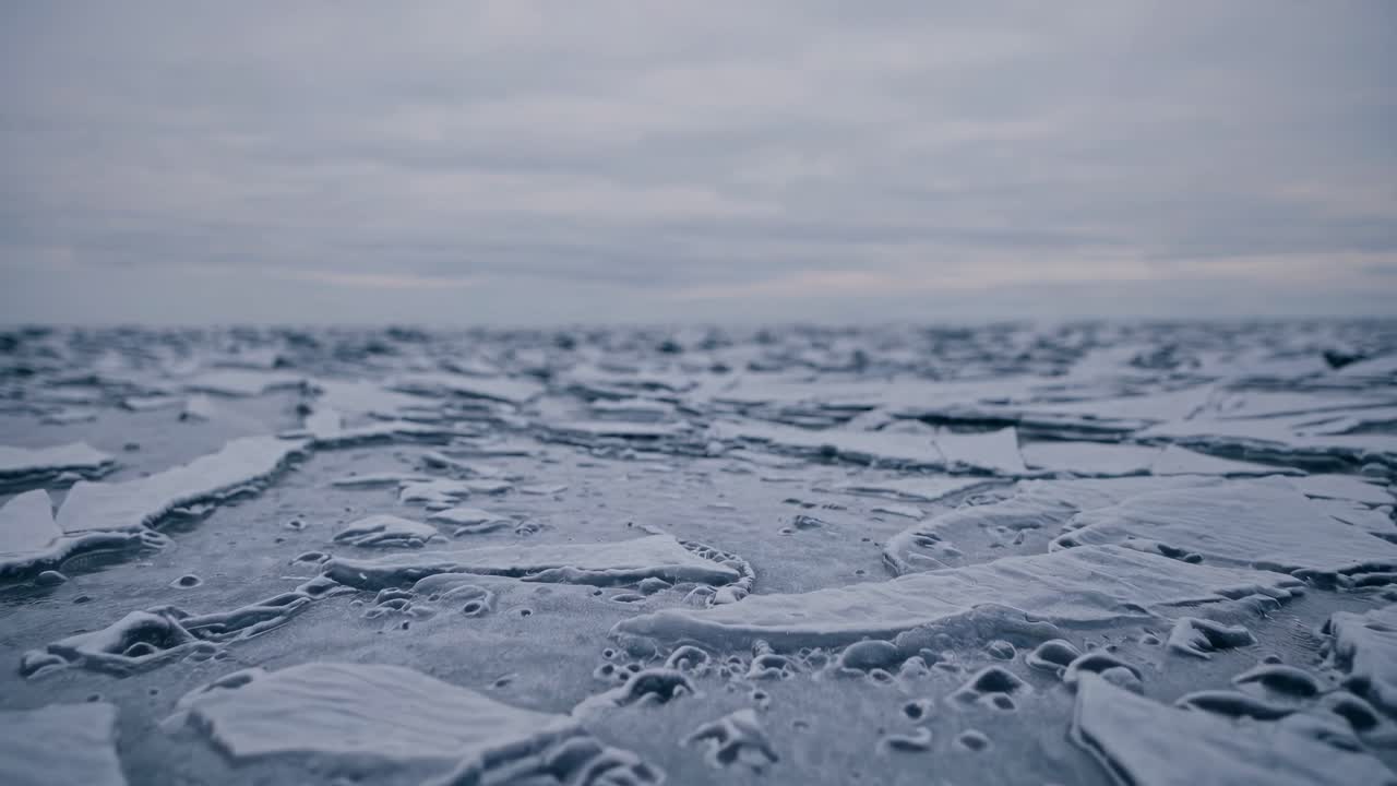 Close-up video of raindrops on a window, captured from a straight-on angle, creating a calming