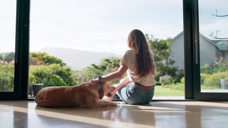 woman petting golden retriever at home
