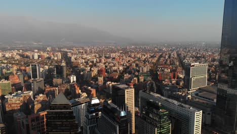 aerial descending and revealing line of skyscrapers on financial district, santiago, chile