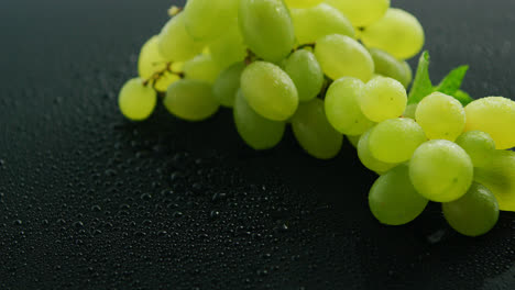 Green-grapes-on-wet-table-