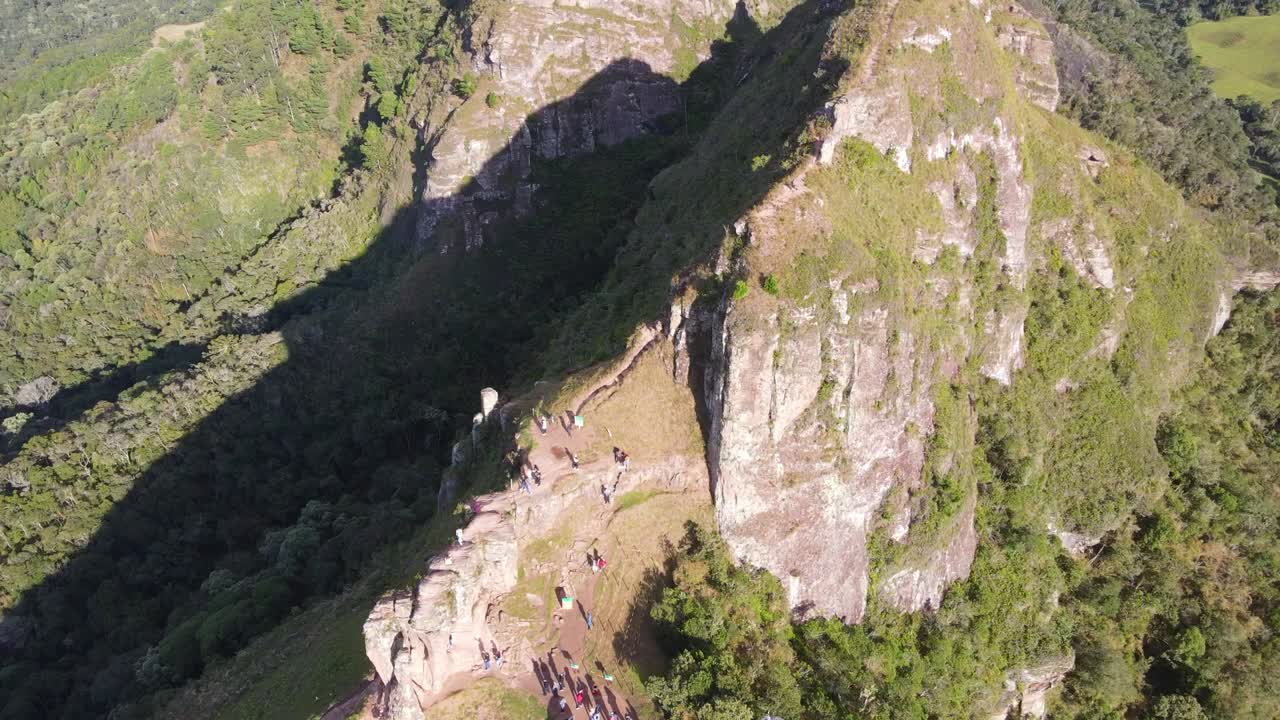 Drone video of people hiking up morro do campestre in Brazil