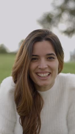 close-up of a young woman smiling outdoors
