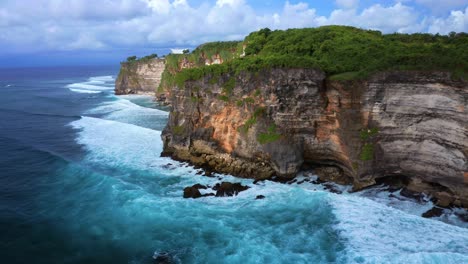 uluwatu cliffs on ocean coast of bali island, indonesia - aerial drone shot