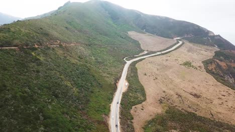 cars drive on beautiful scenic road. aerial forward