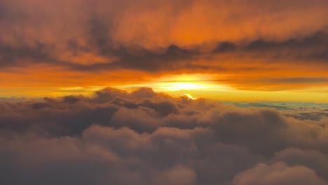 Flying-across-a-red-clouded-sky-during-sunset,-as-seen-by-the-pilots-of-an-airplane-flying-at-10000m-high