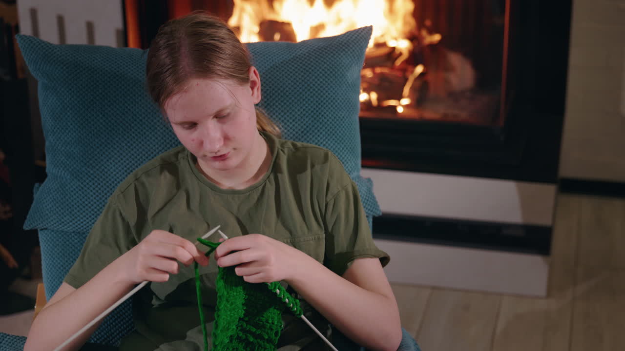 Teenage Girl Knitting by the Fireplace