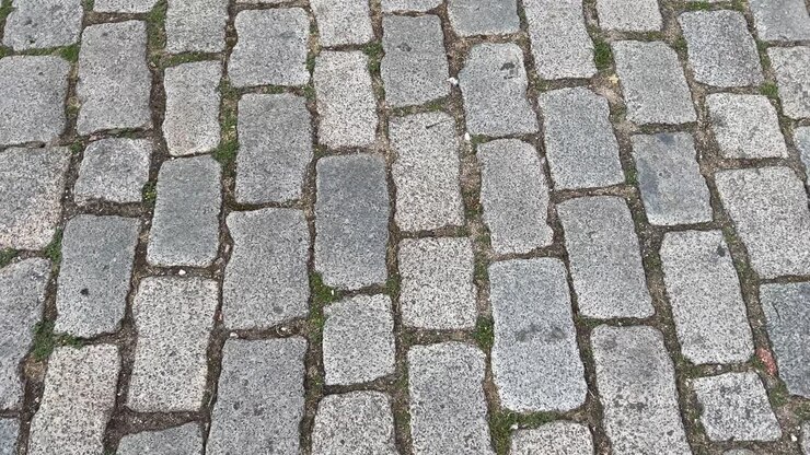 High-angle 180-degree panning shot of cobblestone street in Plovdiv, Bulgaria