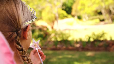 girl dressed up in a fairy costume in garden