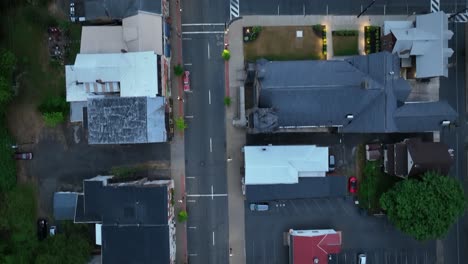 overhead view of downtown milton, pennsylvania with a car moving along with drone video looking down, moving forward