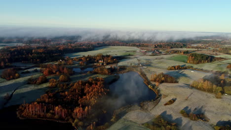 low clouds over rural landscape aerial forward low