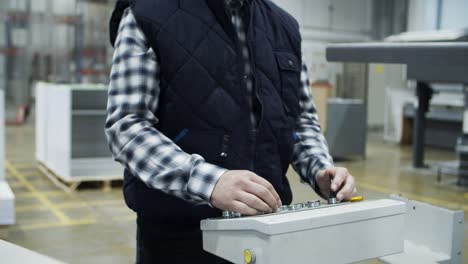 cropped view of male technician setting machine