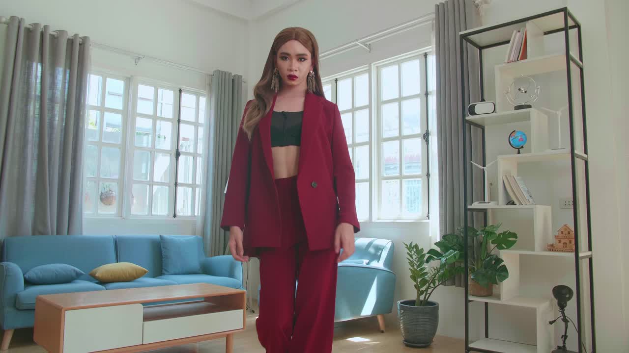 Young Fashion Transgender Woman Wearing Red Clothes Walking And Posing In Home