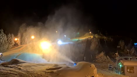 Snow-Making-Machine-at-ski-center,-Snow-Cannon-at-work-in-the-dark,-wide-shot