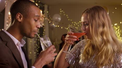 Couple-Make-Toast-As-They-Celebrate-At-Party-Together