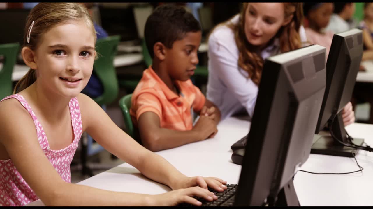 Schoolgirl studying on personal computer in classroom