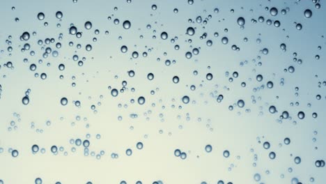 Many-water-bubbles-in-blue-water-close-up,-abstract-water-wave-with-bubbles-in-slow-motion.