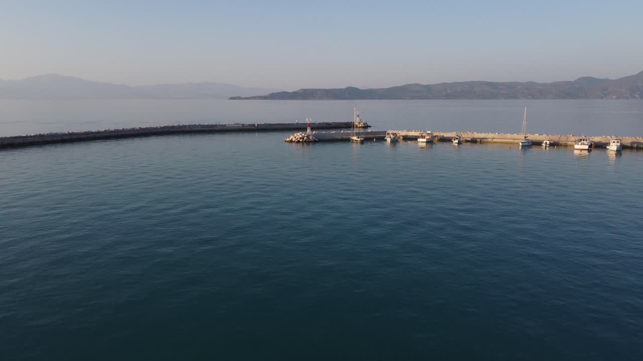 Aerial view from drone to Mediterranean seascape in the marina of Vrahati, Greece with small fishing boats | 4K