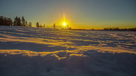 golden sunset time lapse over a winter wonderland - low angle emphasizes the motion, shadows, and reflection on the snow