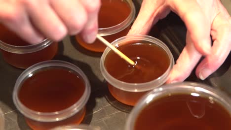 stirring and cooling cannabis salve oil mixed in melted beeswax and shea butter