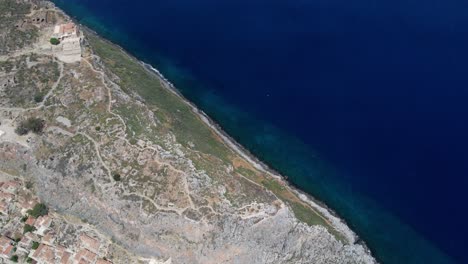 Drone-shot-reveals-Monemvasia-town-landscape-in-Greece-surrounded-by-sea,-Laconia