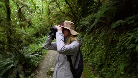 a girl observing birds through binoculars