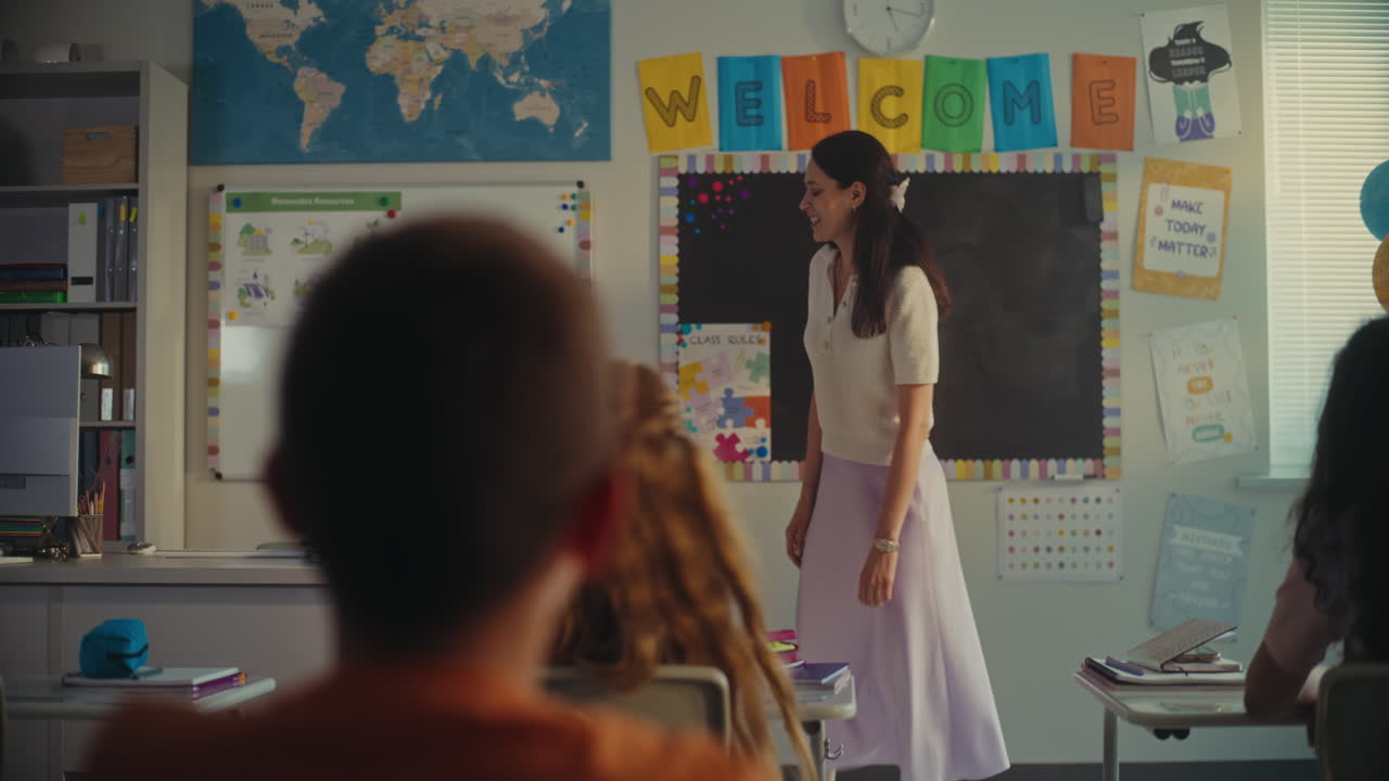 Female Teacher Calling Young Student to the Board During Science Lesson