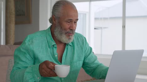 Mature-man-using-laptop-at-home