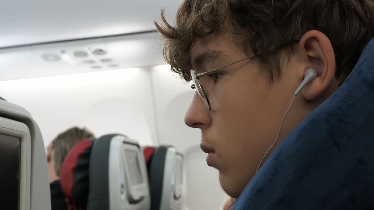 Young Man on Airplane with Headphones