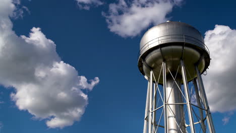 water tower against blue sky with clouds