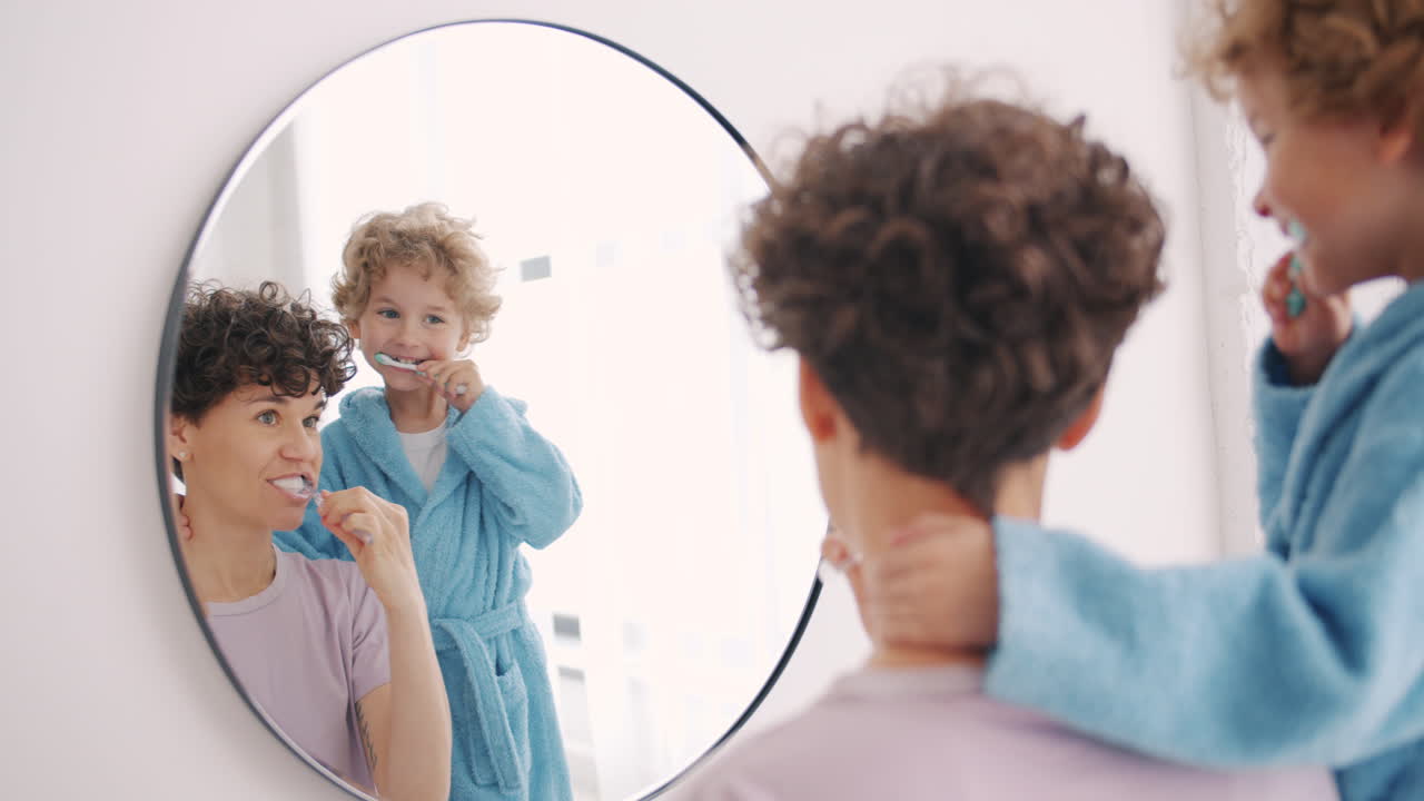 Mother and children brushing their teeth