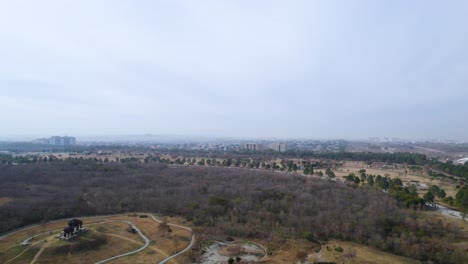 Aerial-shot-of-Park---Aerial-shot-of-F9-Fatima-Jinnah-Park-Islamabad---Drone-footage-of-Islamabad-park-with-Centaurus-mall-in-the-background-and-trees-of-F9-Park-Islamabad,-Pakistan