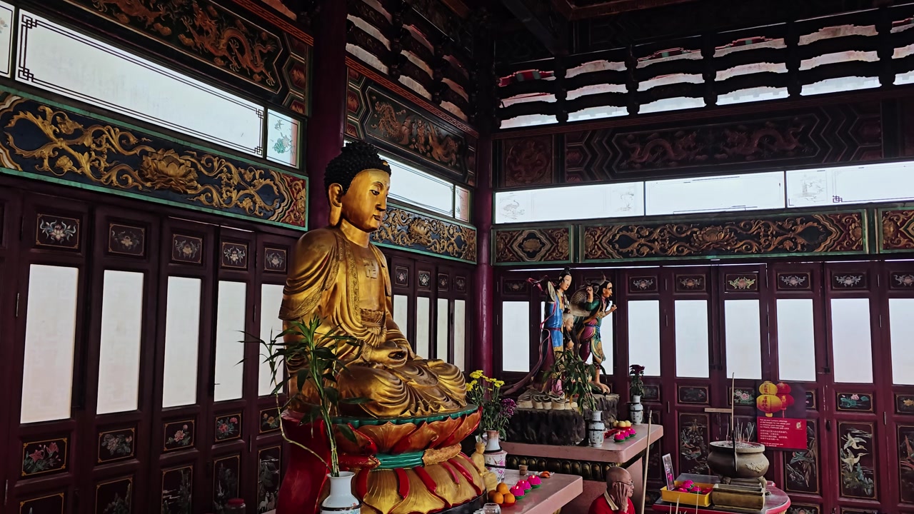 Golden Buddha Statue with People Worshipping in Temple