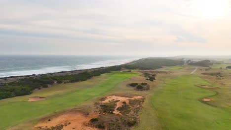 drone footage captures expansive views of barwon heads golf course and coastline under soft, natural lighting