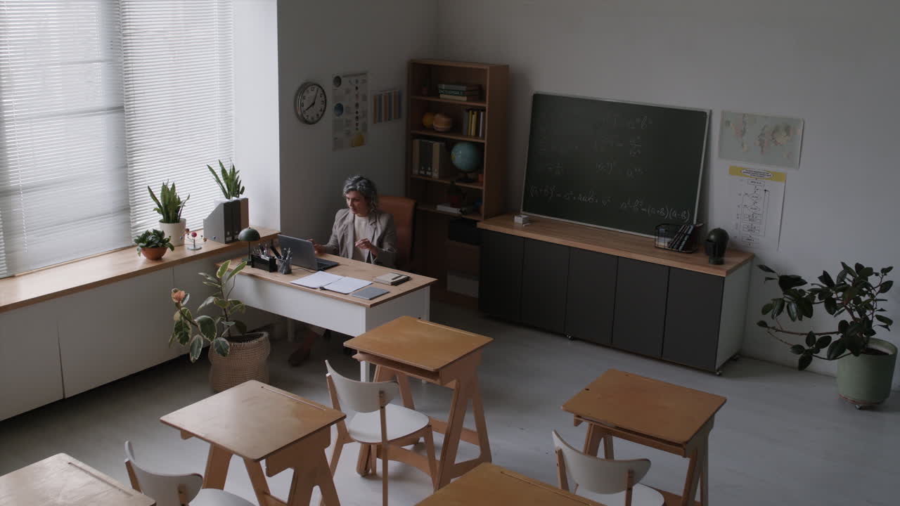 Classroom scene with teacher at desk