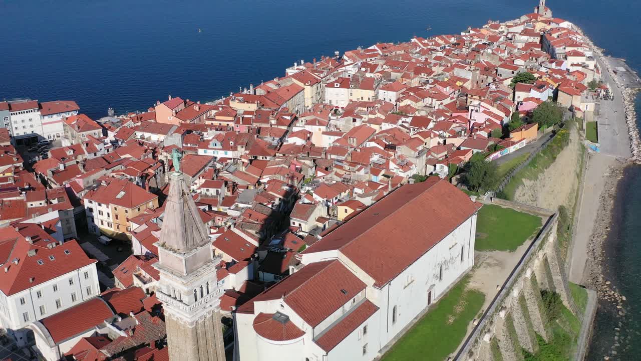 amazing view of Church of Saint George and Piran town by Adriatic sea. Aerial